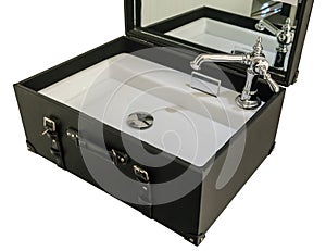 Ceramic basin and silver metal faucet set in black leather suitcase for decoration