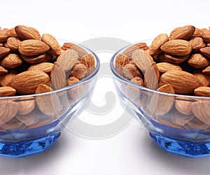 Ceramic bowl of almonds with white background