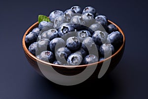 Ceramic bowl brims with delicious fresh vegan sweet blueberries
