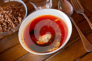 Ceramic bowl with hodgepodge on a wooden table photo