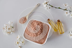 Ceramic bowl with red clay powder, ingredients for homemade facial and body mask or scrub
