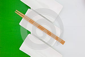 Ceramic bowls and bamboo chopsticks on wooden table