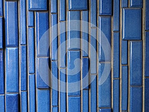 Ceramic brick pattern background photograph, vertical blue glazed bricks.