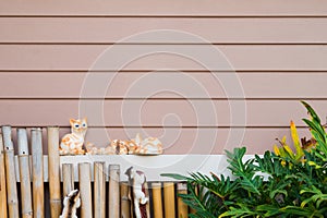 Ceramic cats and squirels with horizontal wood plank background