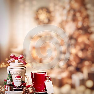 The Ceramic Christmas coffee set with price tag is on the bokeh Christmas scene.