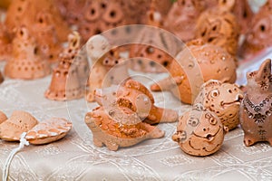 Ceramic clay figure toys of handmade and handcrafted fantastic imaginary animals on sale at ethno festival