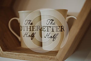 Ceramic couple mugs on a shelf