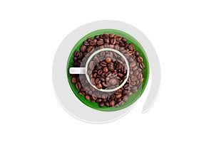 Ceramic cup on a green saucer filled with coffee beans