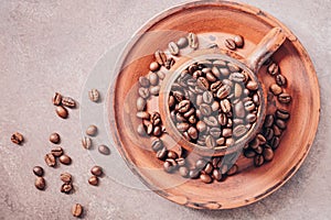 Ceramic cup with roasted coffee beans. Symbolic image. Top view, selective focus