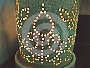 Ceramic diffuser filled with natural essential oil diluted light candles photo
