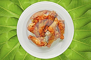 Ceramic dish of fried chicken drumstick for dinner