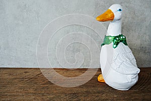 Ceramic duck interior decor with space copy on wooden background
