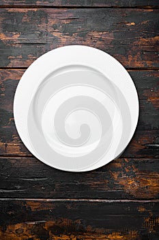 Ceramic empty white plate with copy space for text or food with copy space for text or food, top view flat lay , on old dark