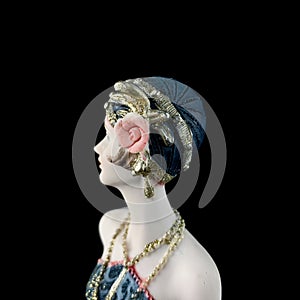 Ceramic figurine of a fantastic woman in a blue dress on a black background. porcelain antique figurine of a woman in retro clothe