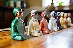 ceramic figurines of disciples on a wooden table