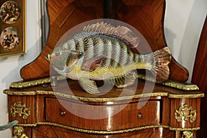 Ceramic fish figurine on a vintage shelf