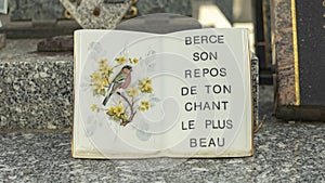 Ceramic funerary book, adorned with a bird and the inscription: \