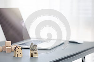 Ceramic home model with laptop on table