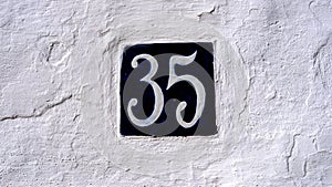 ceramic house number table. number: 35. on a white background