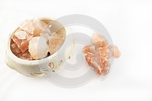 Ceramic jar with salt stones. photo