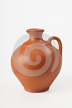 Ceramic jug for olive oil and grape wine on a white background. . Close-up.