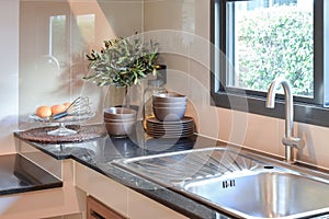 Ceramic kitchenware on the marble worktop and shelf