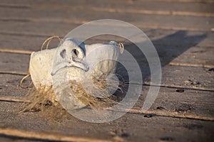 Ceramic mask on the wooden background