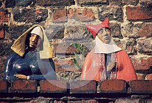 Ceramic Medieval Figures Sit on a Wall in ToruÃâ, Poland