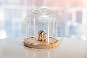 Ceramic model of house under glass cap