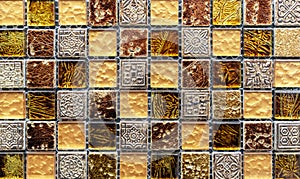 Ceramic mosaic tiles with yellow and brown embossed squares to decorate the kitchen, bathroom or pool