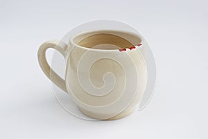 Ceramic mug with red spots painted with overglaze paint. handmade.
