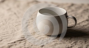 Ceramic mug with a round shape and a small handle is placed on a