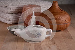 Ceramic Neti pot for nasal cleansing, wooden humidifier, salt lamp and nasal spray stock images
