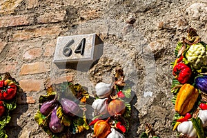 Ceramic number sixty four 64 on a brick wall