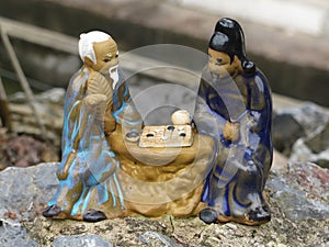 Ceramic ornament of two old asian men playing chess