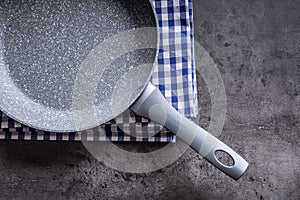 Ceramic pan on concrete kitchen board. Kitchen utensil. Empty pan