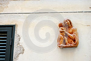 Ceramic plate of Mary with Baby Jesus in Manarola, one of the five centuries-old villages of Cinque Terre, Liguria, Italy