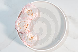 Ceramic plate mock up, round dish on a marble background with rose flowers, concrete home decor, template for product