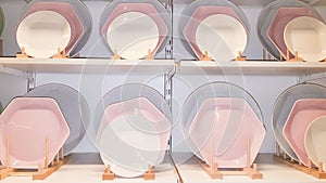 Ceramic plates dishes white and pink on shop shelves Department Store