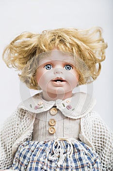 Ceramic porcelain doll with curly blond hair