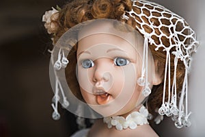 Ceramic porcelain handmade doll with big blue eyes and curly hair