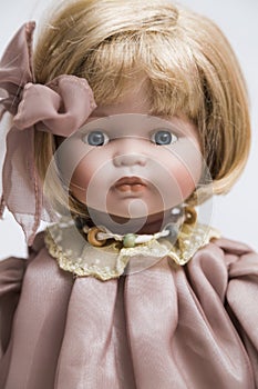 Ceramic porcelain handmade doll with blond hair and pink dress