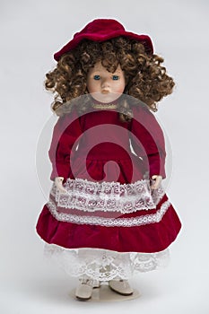 Ceramic porcelain handmade doll with curly brown hair and red dress