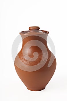 Ceramic from red clay jug with a lid on a white background. Isolated. Close-up.