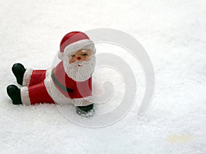 Ceramic santa claus on snow background. Lovely Merry Christmas and Happy New Year 2018 on snowfall background.