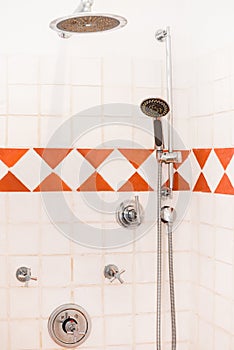 Ceramic shower tiles cabin with metal head in modern bathroom