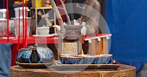 Ceramic tea pot with bowls on display.