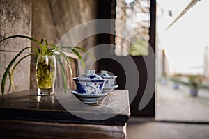 Ceramic teacups on table at ancient Chinese dwelling house