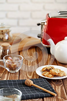 Ceramic teapot and toaster, kitchen table close up