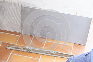 Ceramic tile installation site with its tools